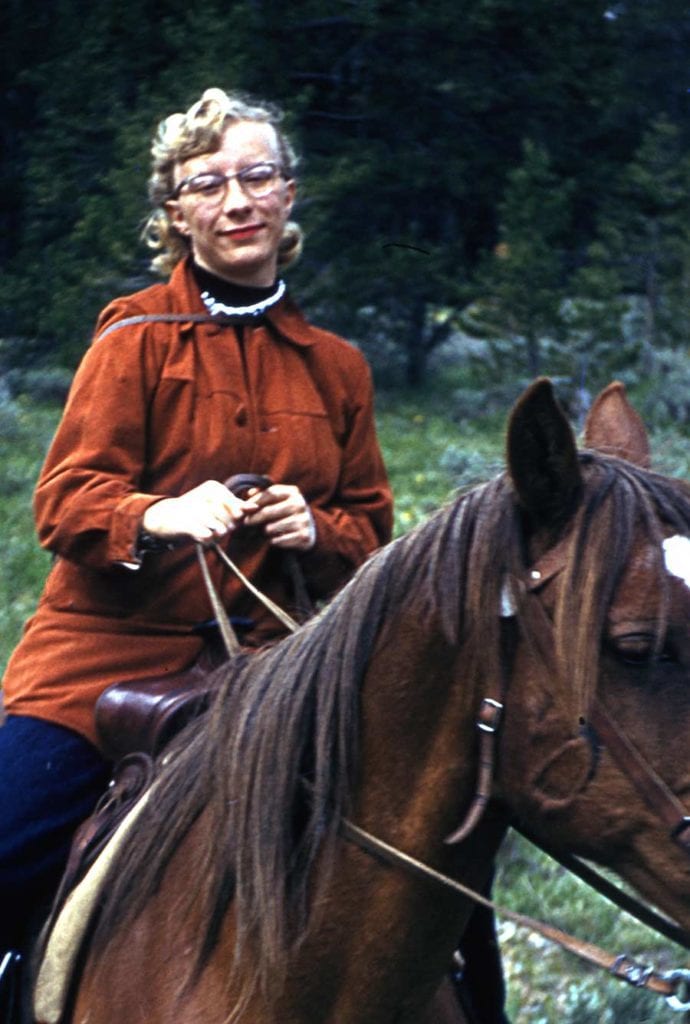 Photo: Anita Wimberly Ouverson riding horseback, apparently wearing pearls. Circa 1955.